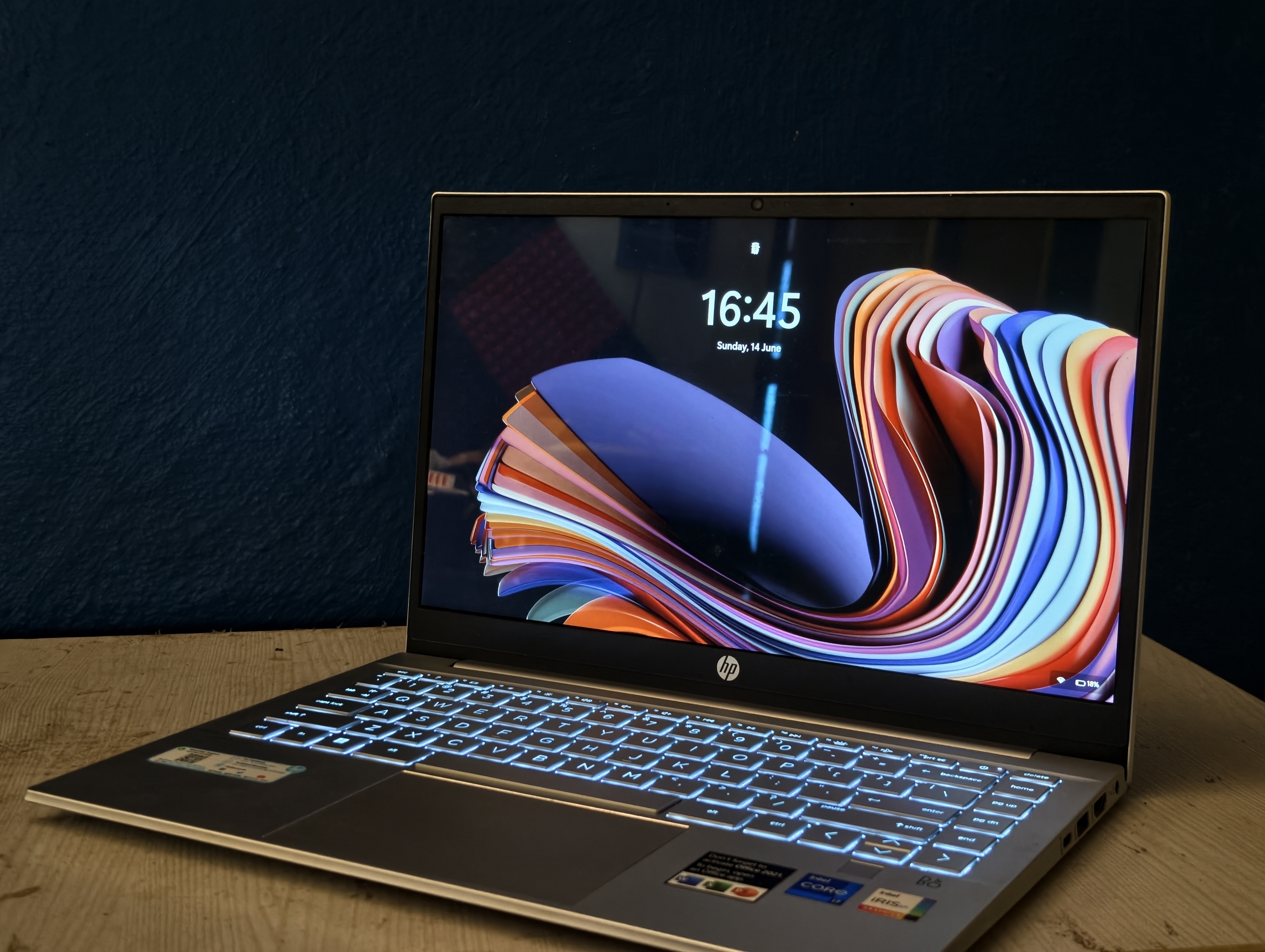 Three-quarter view of HP Pavilion 14, sitting on a glass desk